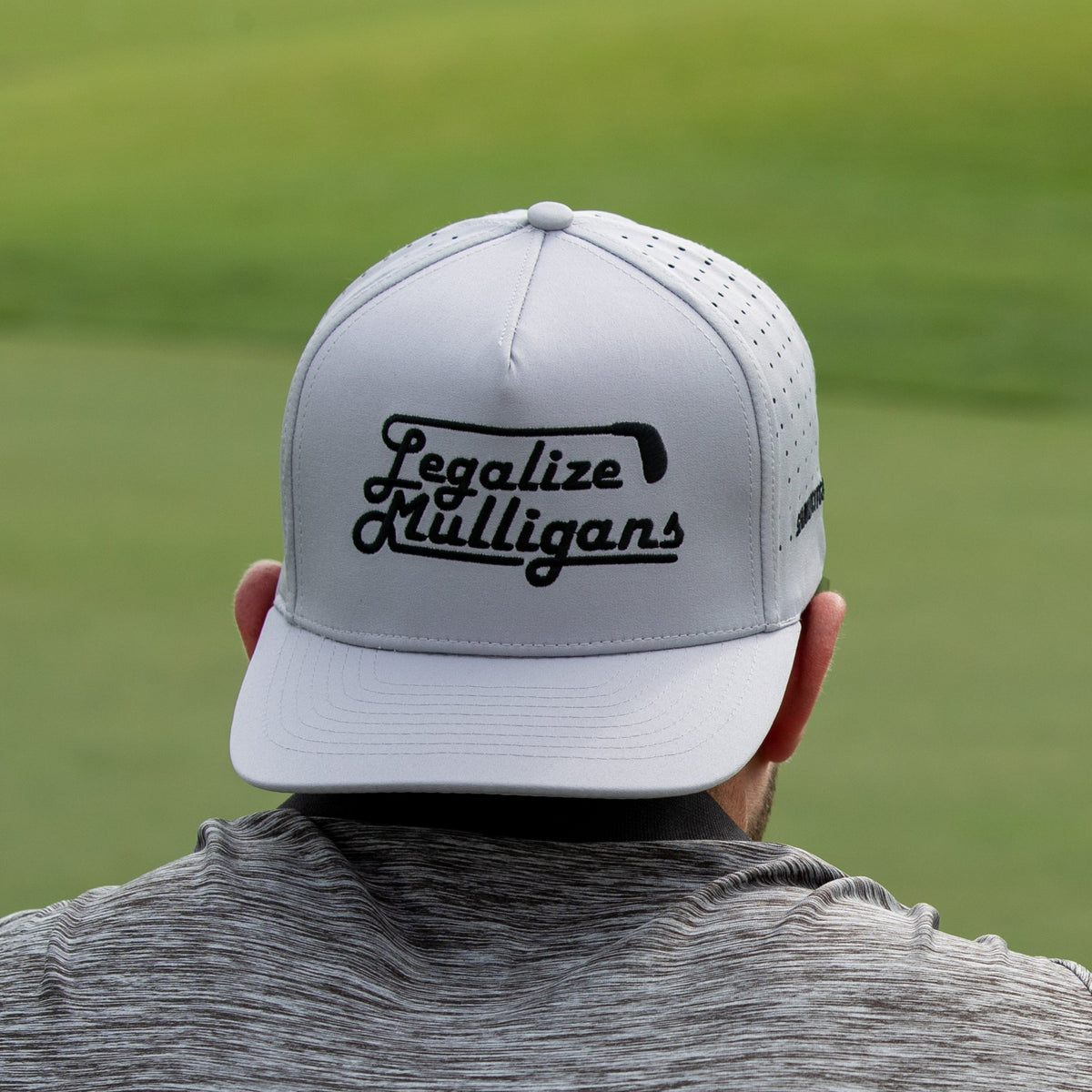 Gray golf hat with &quot;Legalize Mulligans&quot; embroidered in white text, ideal for avid golfers.