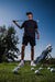 Men’s black polo with subtle gray-white speckle “cosmic sprinkle” print – sleek, breathable, stretch-performance ready.
