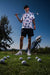 Men’s white polo with vibrant green and pink palm tree print – tropical feel with stretch, moisture control, and wrinkle resistance.