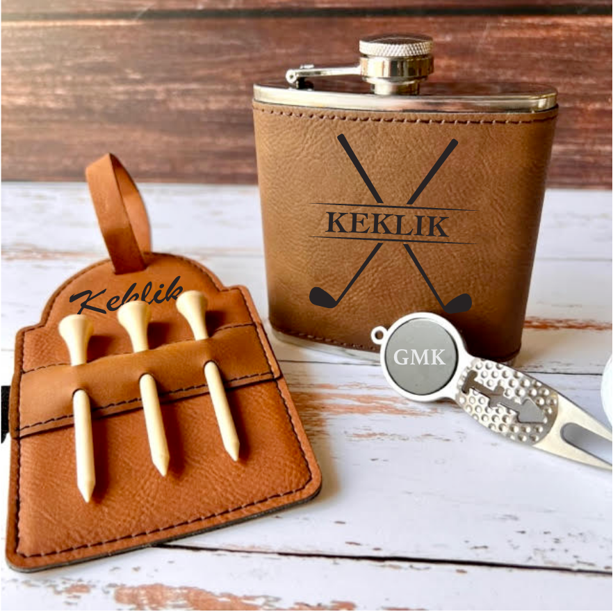 Golf gift set with flask, vegan leather tag, and divot tool in gift-ready packaging