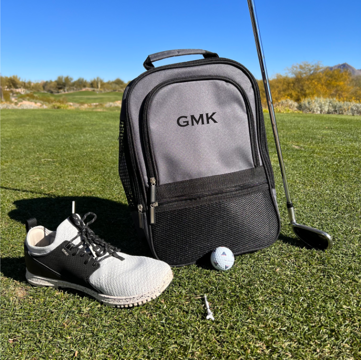 Personalized golf shoe bag with mesh pockets and zipper closure.