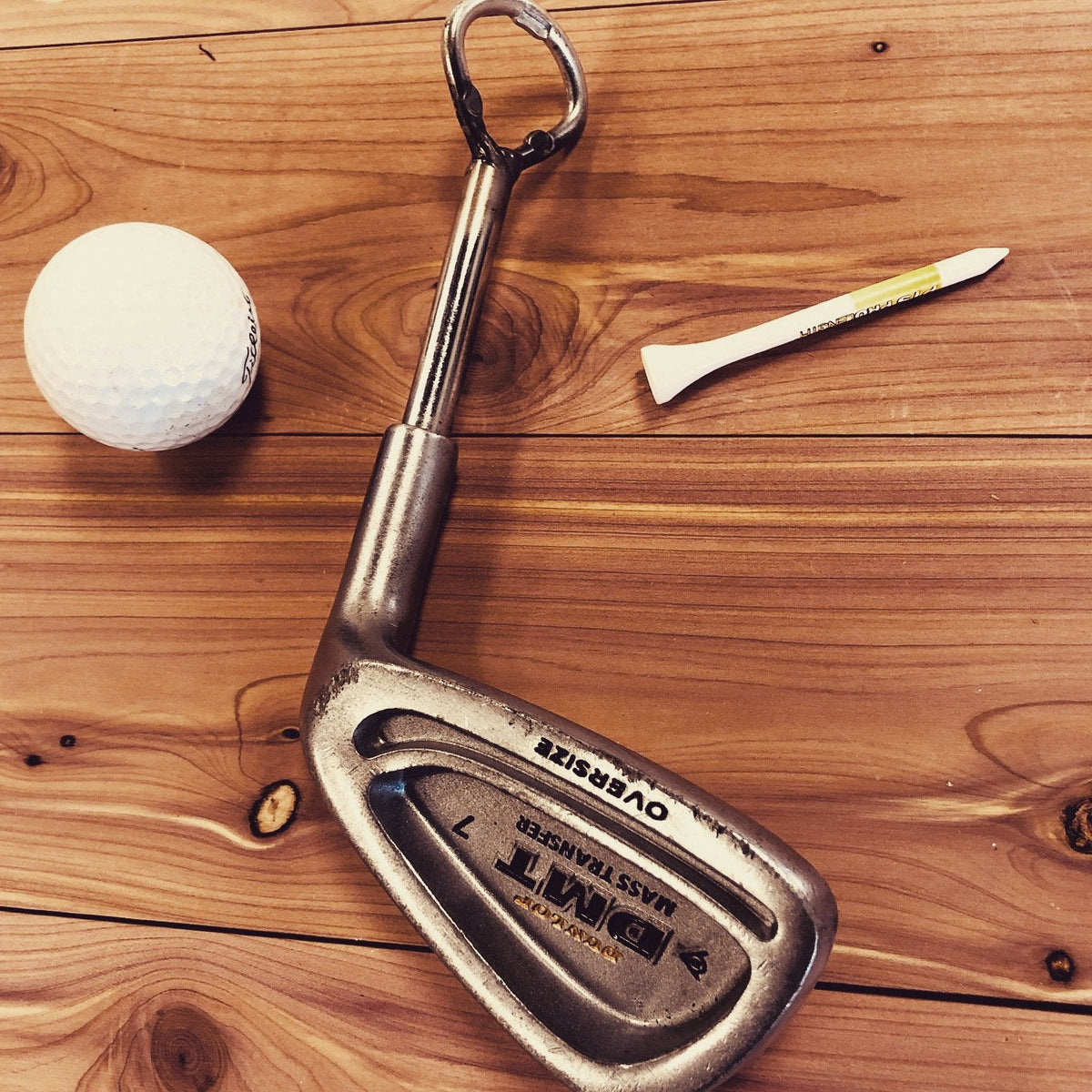 Classic golf club bottle opener made from recycled materials.
