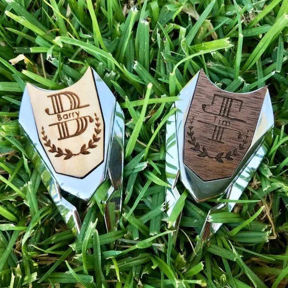 Golf divot tool with custom material, design, and engraving options.